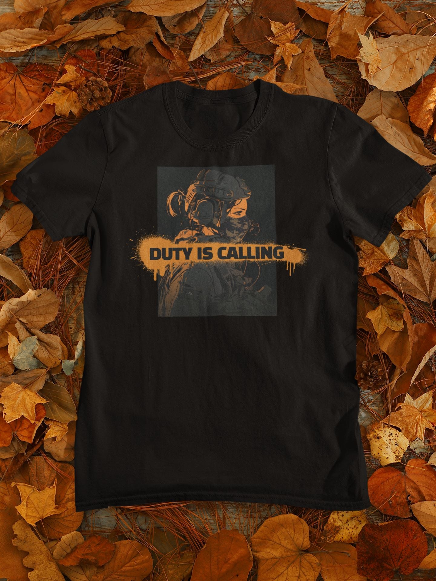 Black t-shirt with 'Duty is Calling' graphic on a bed of autumn leaves