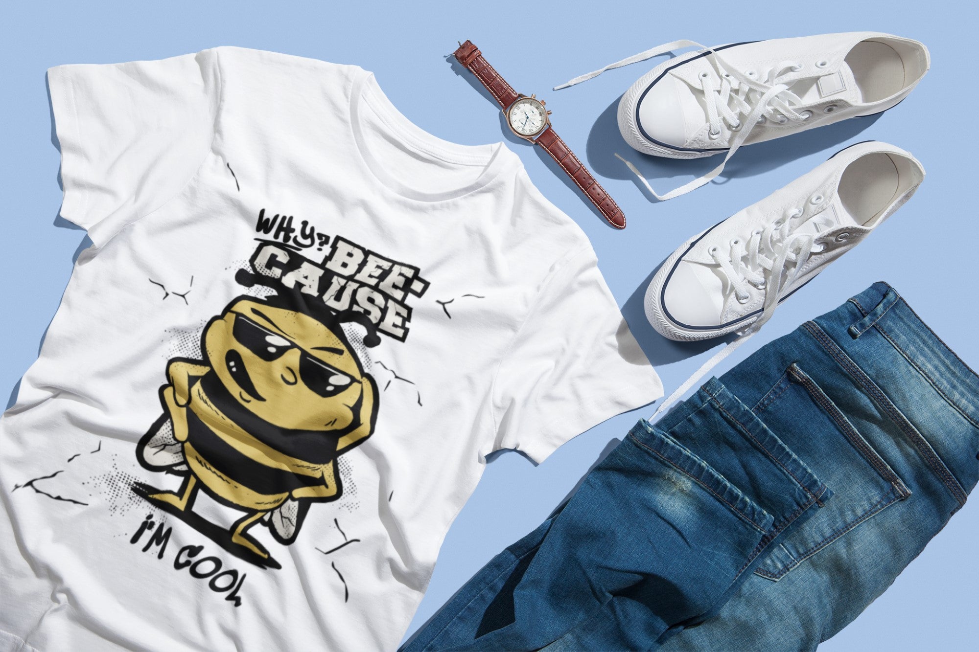 White t-shirt with bee graphic, white sneakers, blue jeans, and watch on a light blue background