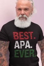 A man with a white beard and tattoos wearing a black t-shirt with the text 'BEST. APA.