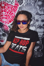 Person wearing a black t-shirt with 'HIP HOP BEATS' text in front of a colorful abstract background