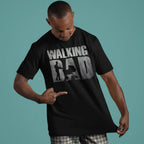 Man wearing a black t-shirt with 'WALKING BAD' graphic design on a teal background