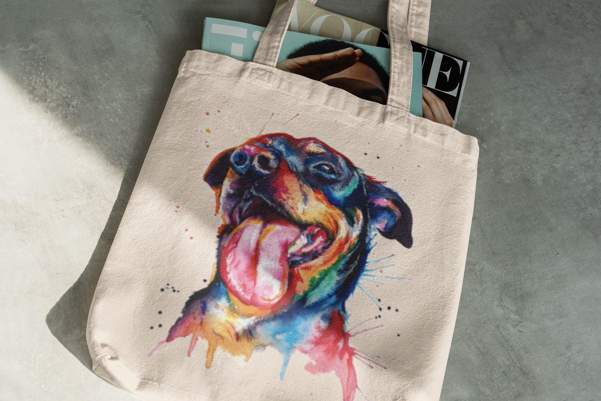 Tote bag with a colorful dog illustration on a gray surface