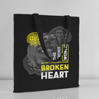 Black tote bag with graphic design and text on a gray background