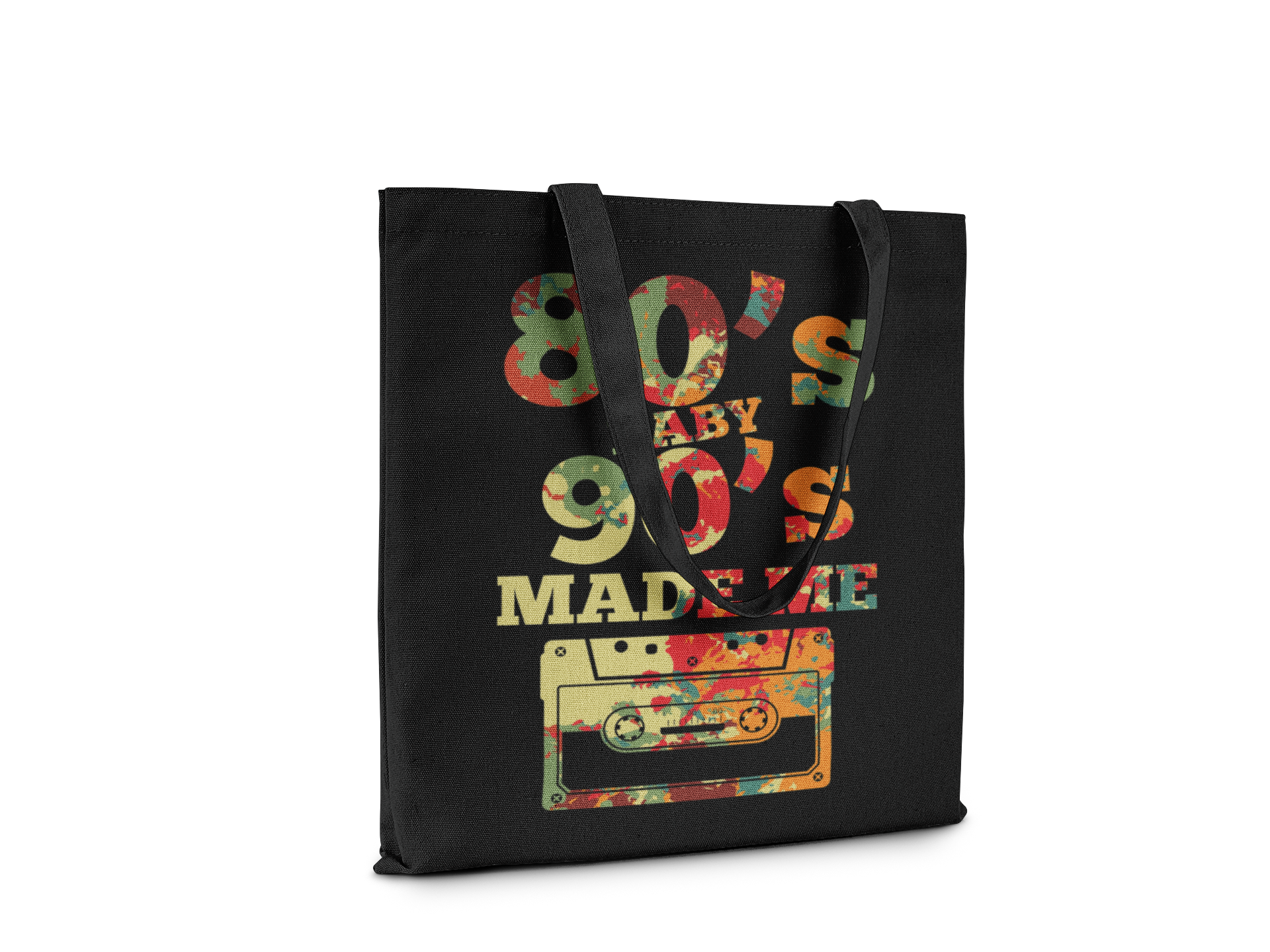 Black tote bag with colorful '80s baby 90s made me' text and cassette tape graphic on a white background