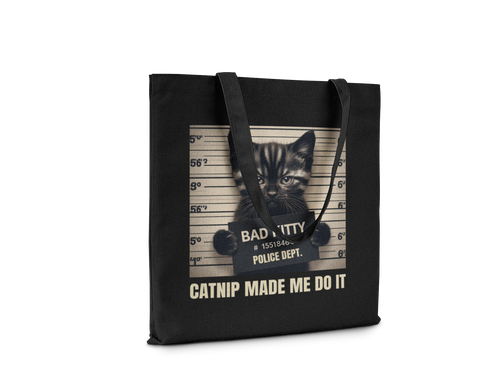 Black tote bag with a kitten graphic and text on a white background