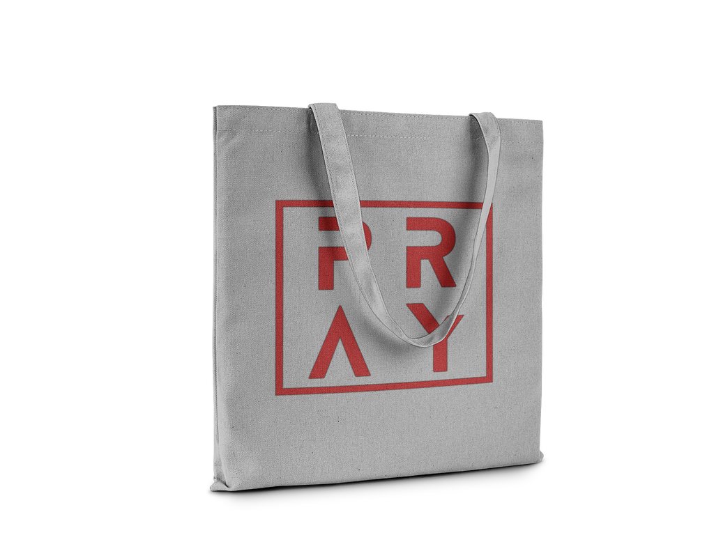 Gray tote bag with red 'PRAY' text on a white background