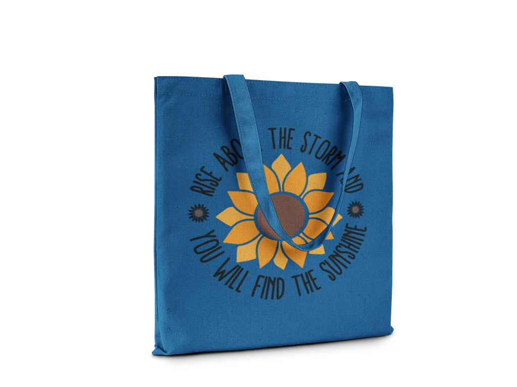 Blue tote bag with sunflower design and motivational quote on a white background
