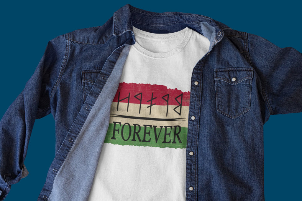 White t-shirt with colorful design and text under a denim jacket on a blue background