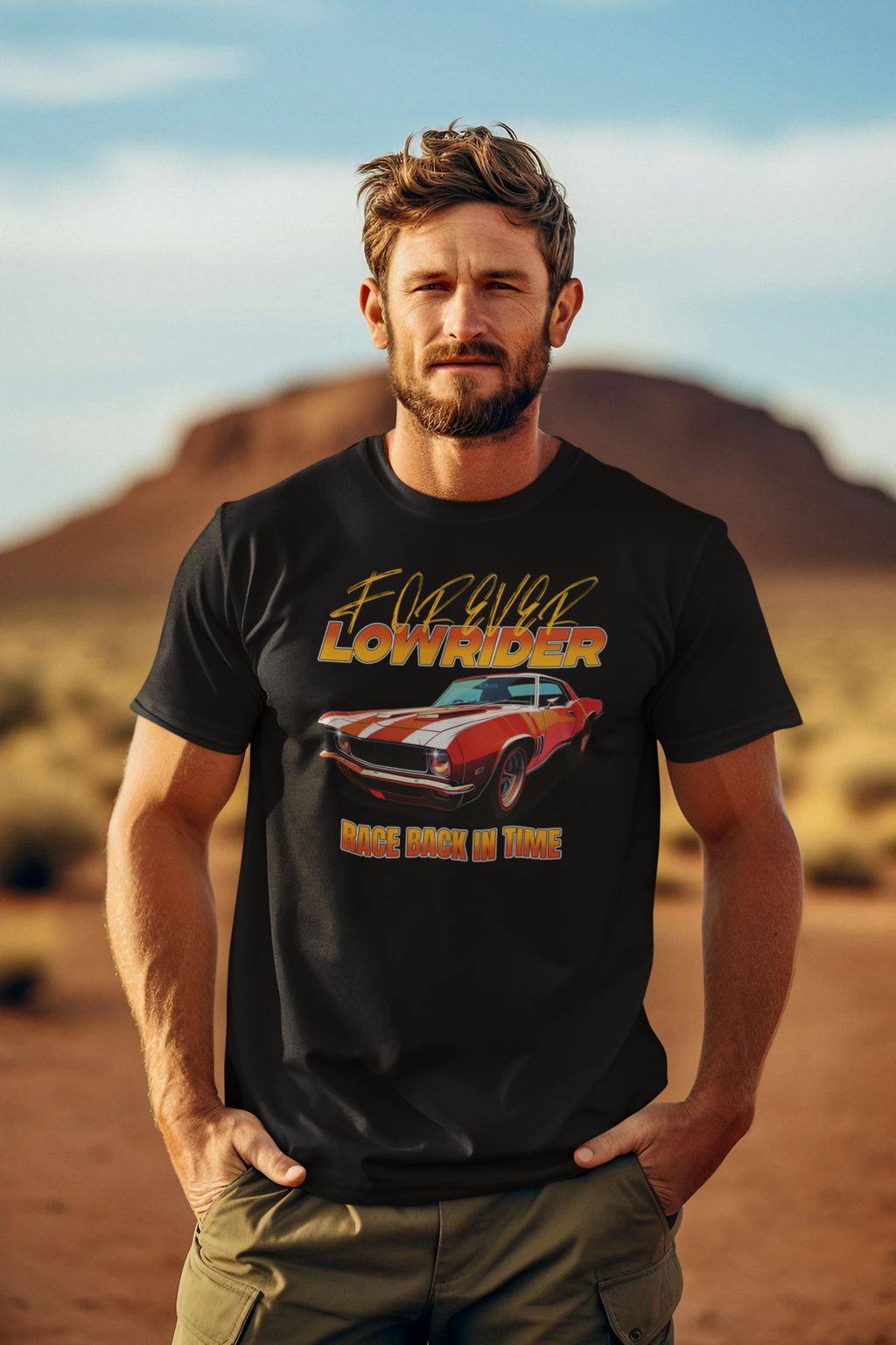 Man wearing a black t-shirt with a graphic design of a car and text, standing in a desert landscape.